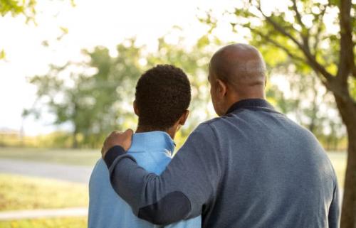 dads arm around adult son